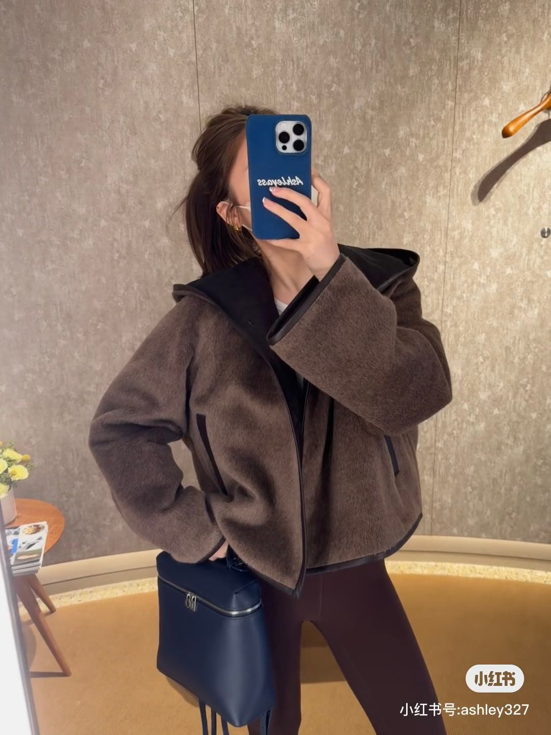 Her new alpaca wool hooded jacket