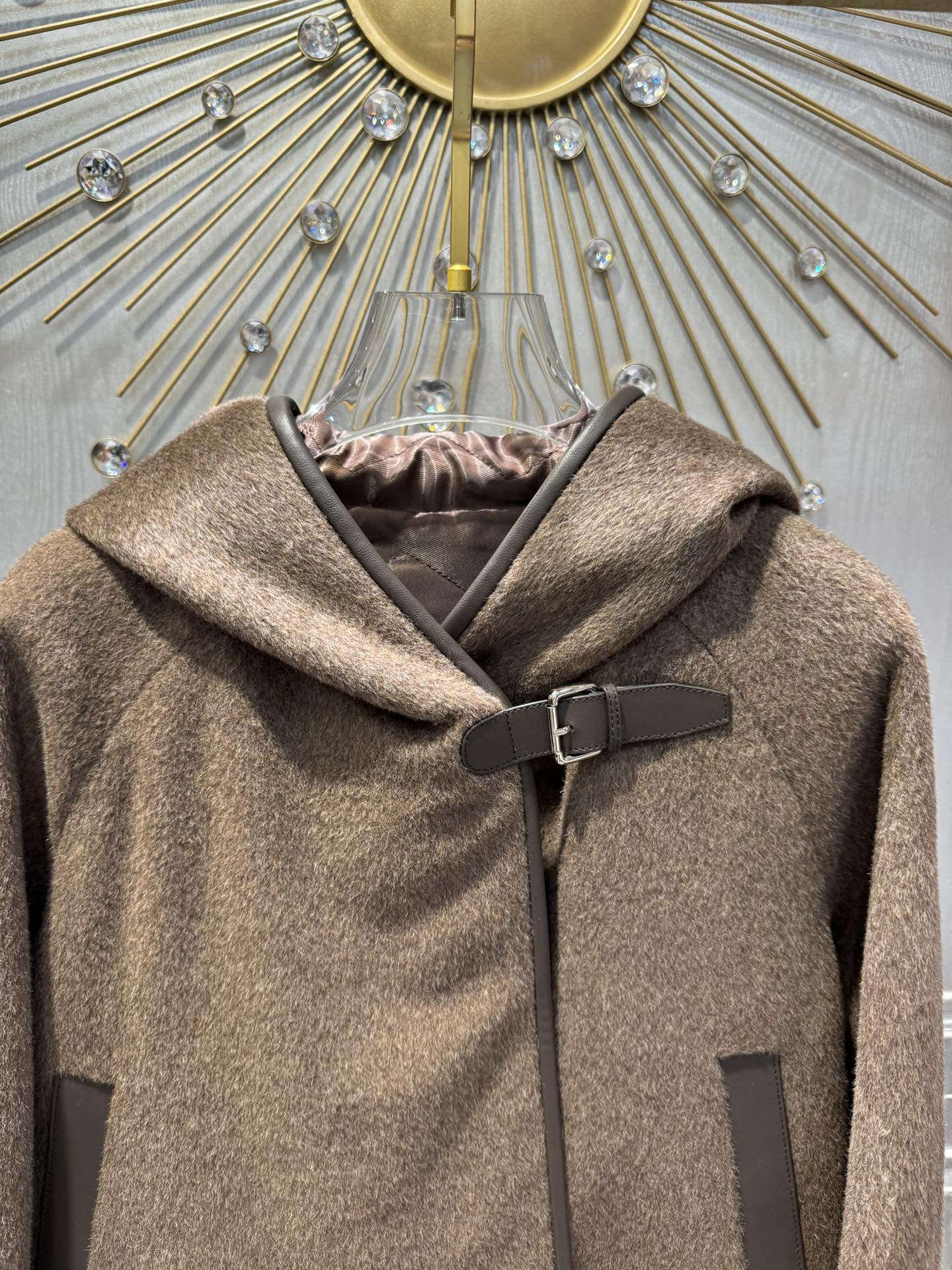 Her new alpaca wool hooded jacket