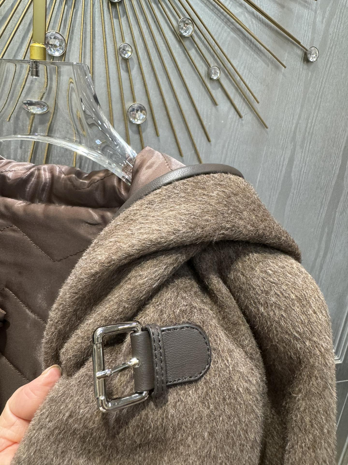 Her new alpaca wool hooded jacket