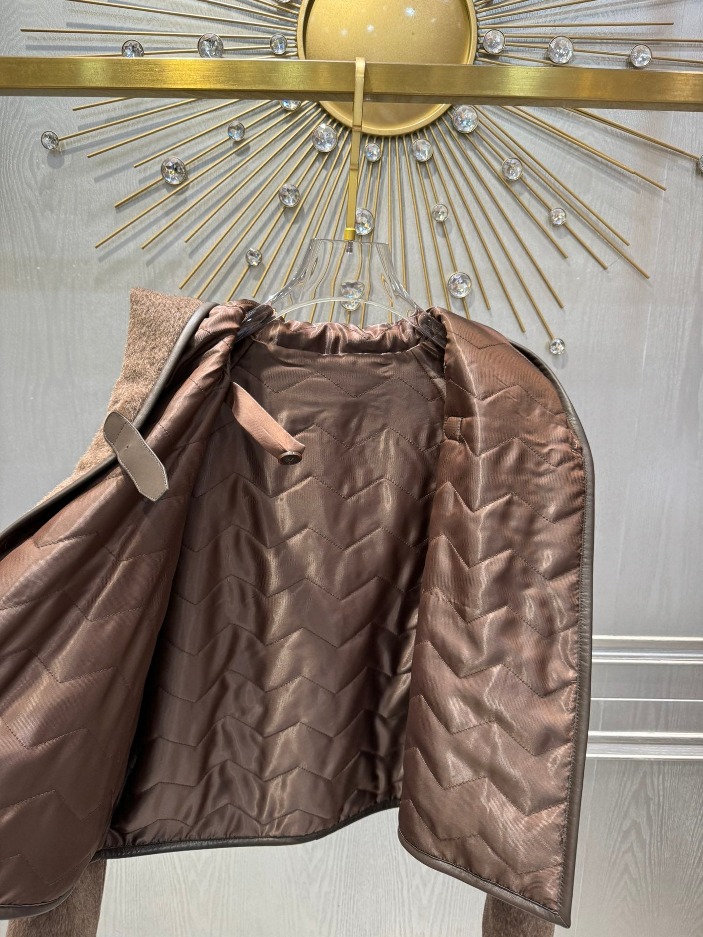 Her new alpaca wool hooded jacket