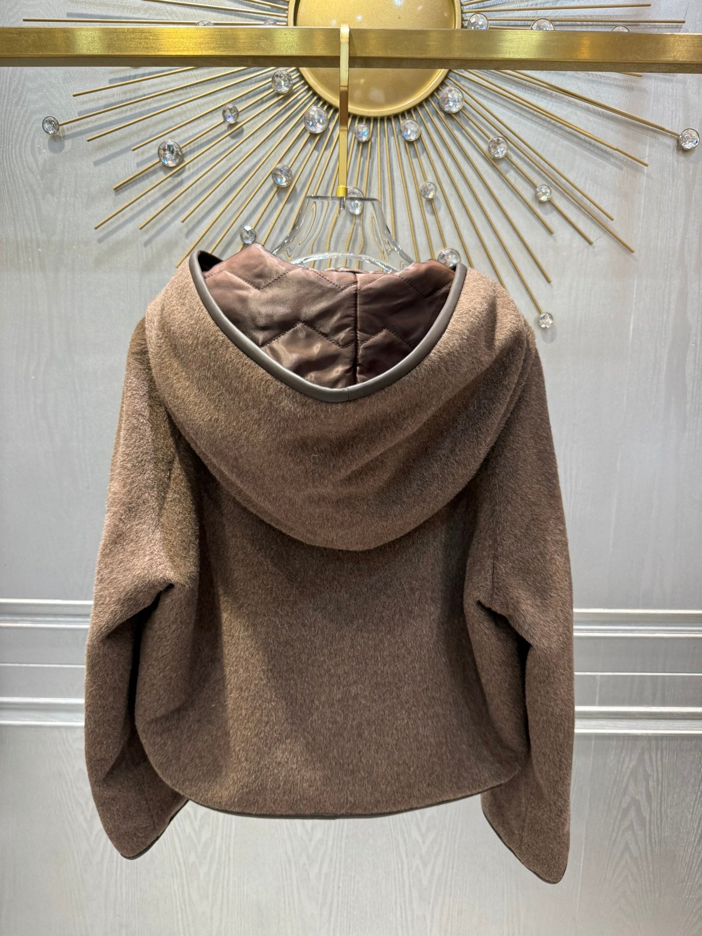 Her new alpaca wool hooded jacket